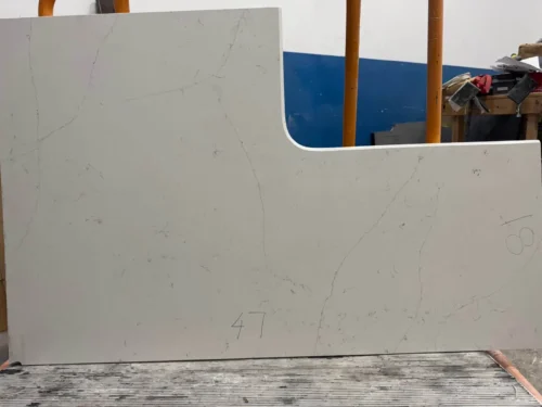 This quartz slab has a soft white base with subtle, fine gray veining for a clean and timeless aesthetic. Its elegant design makes it perfect for small vanity tops, shower seats, window sills, door sills, or similar applications.