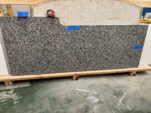 IMG_8997-1-scaled This granite slab features a classic speckled pattern with a mix of black, gray, and white tones, offering a durable and timeless look. Its strong composition makes it ideal for small vanity tops, shower seats, window sills, door sills, or similar applications.