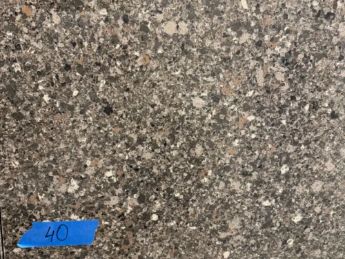IMG_9071-scaled This quartz features a natural, stone-like appearance with speckled patterns in black, brown, and rusty hues. The mix of earthy tones creates a warm, organic look, offering a sophisticated yet rustic feel. Perfect for those seeking a durable, low-maintenance surface with the beauty of natural stone for countertops, vanities, and other design elements.